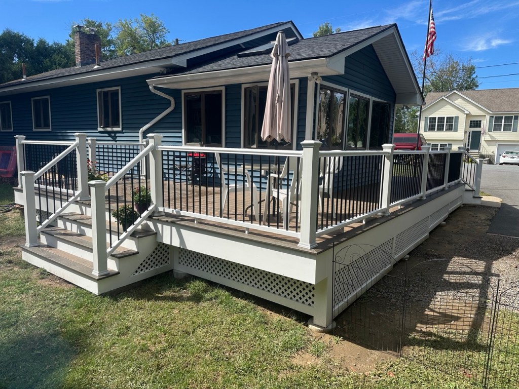 deck with blue house from yard - 2