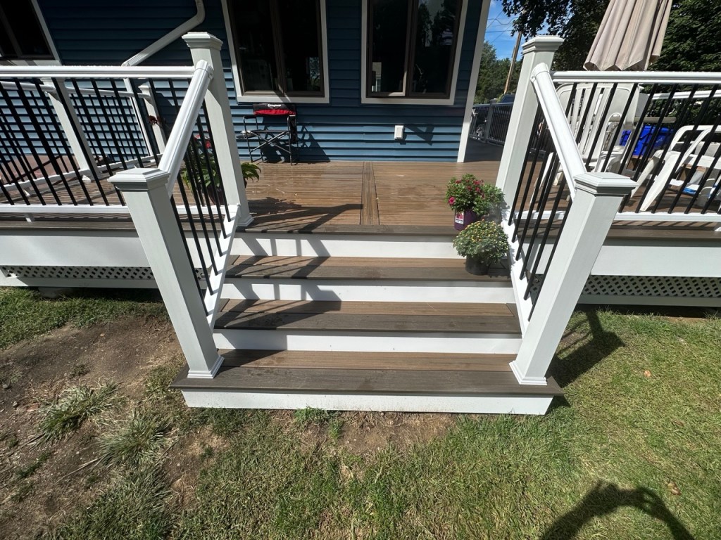 front of deck with blue house